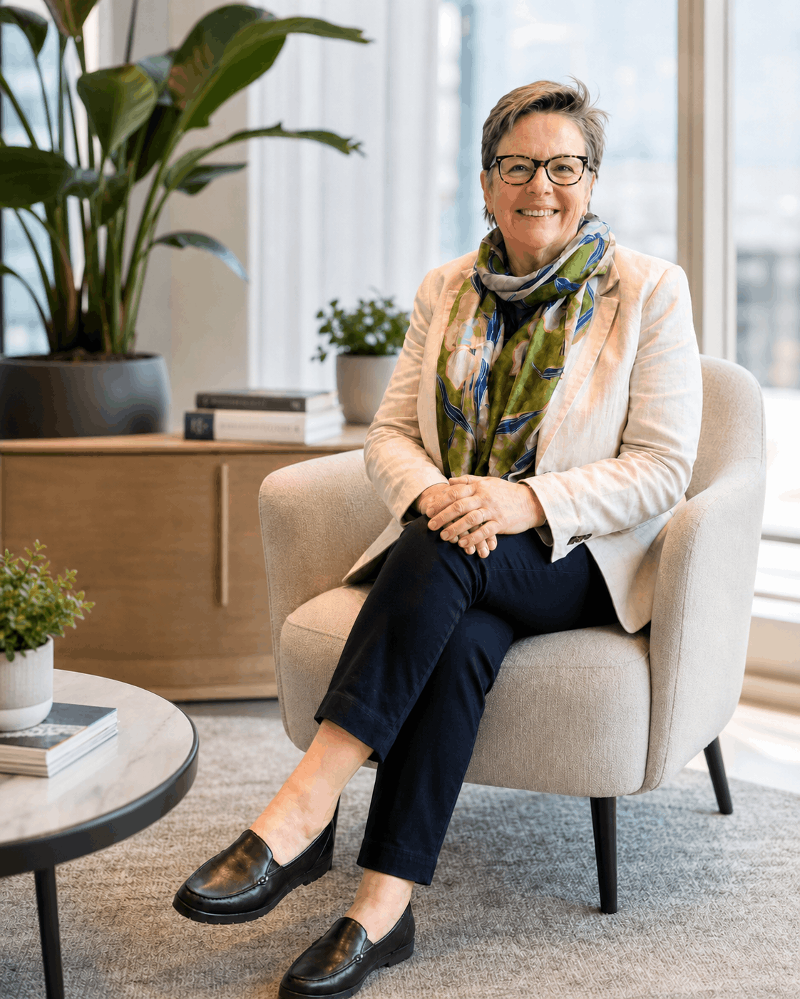 Cath Watkins seated in a bright professional setting